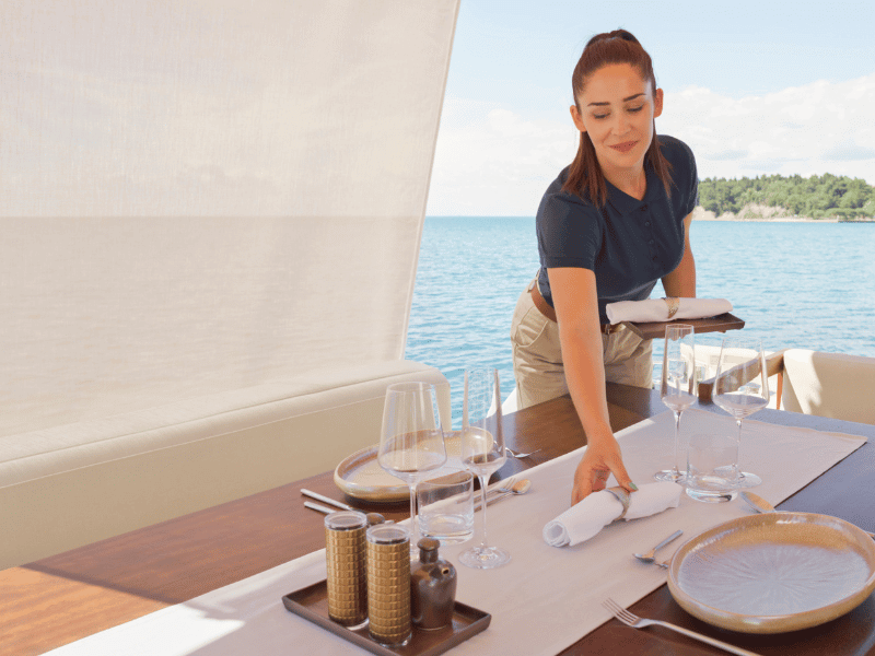 yacht stewardess making the table