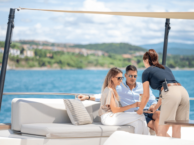 yacht stewardess serving guests